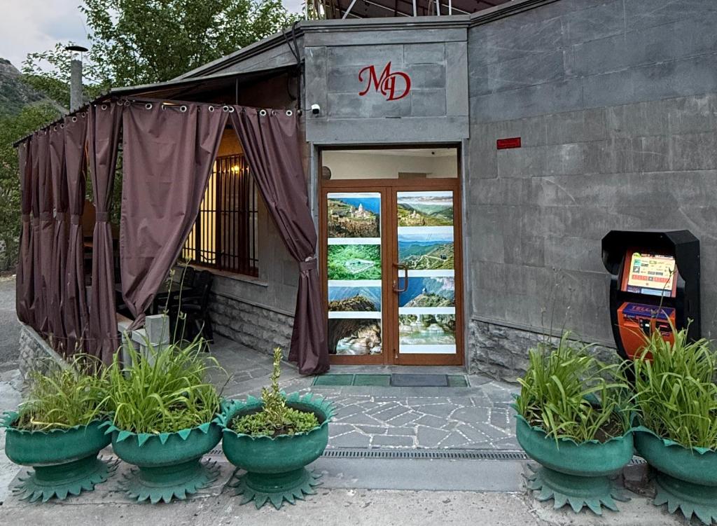 a group of plants in pots outside of a building at Guest House in Halidzor