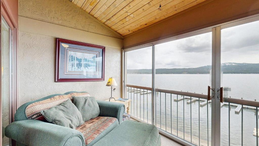 a living room with a couch and a large window at Crystal Beach Condo - Lake Views & Pool in McCall