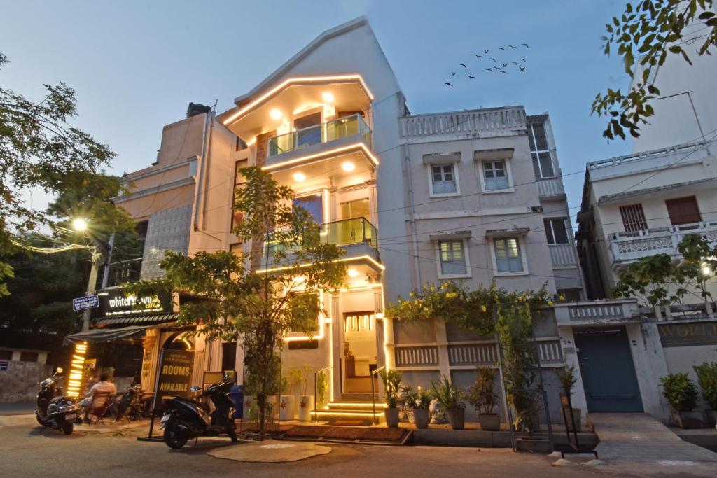 a building with a motorcycle parked in front of it at Hotel De Lux Splendid in Pondicherry