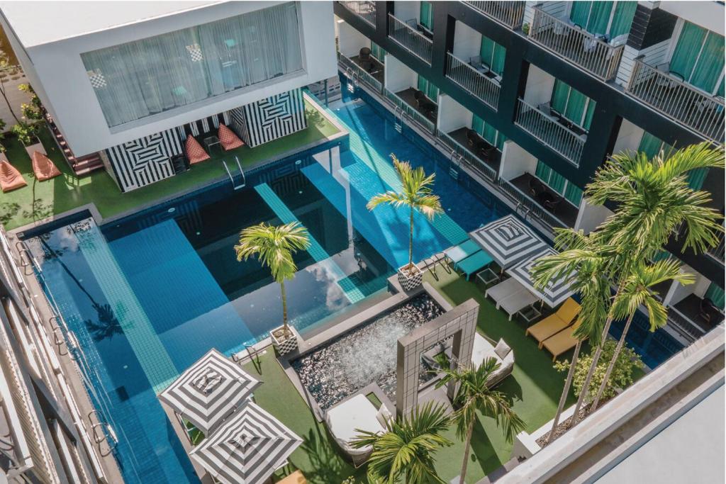 an overhead view of a hotel swimming pool with palm trees at Sugar Marina Hotel - FASHION - Kata Beach in Kata Beach