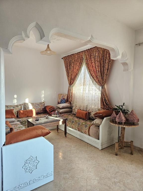 a living room with a couch and a window at Pearl studio avec terrasse in Larache