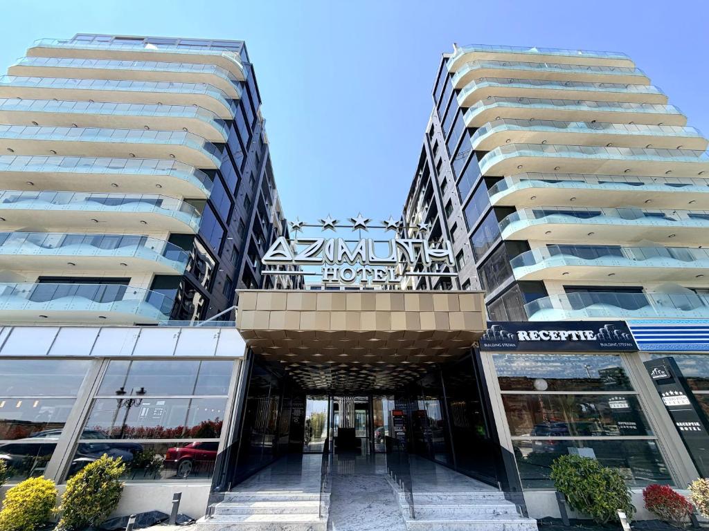 two tall buildings next to a shopping mall at Mamaia-NordCom Apartamente Exclusiviste S Resort 1 CBN la plaja Azimuth in Mamaia Sat/Năvodari