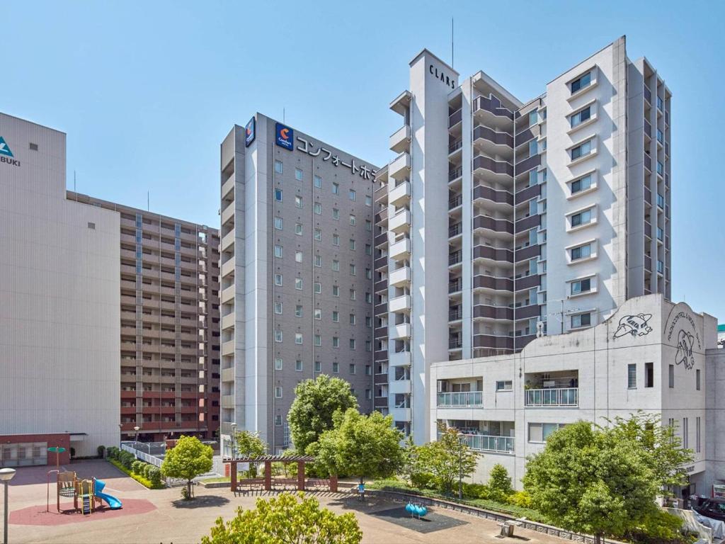 a group of tall buildings in a city at Comfort Hotel Kure in Kure