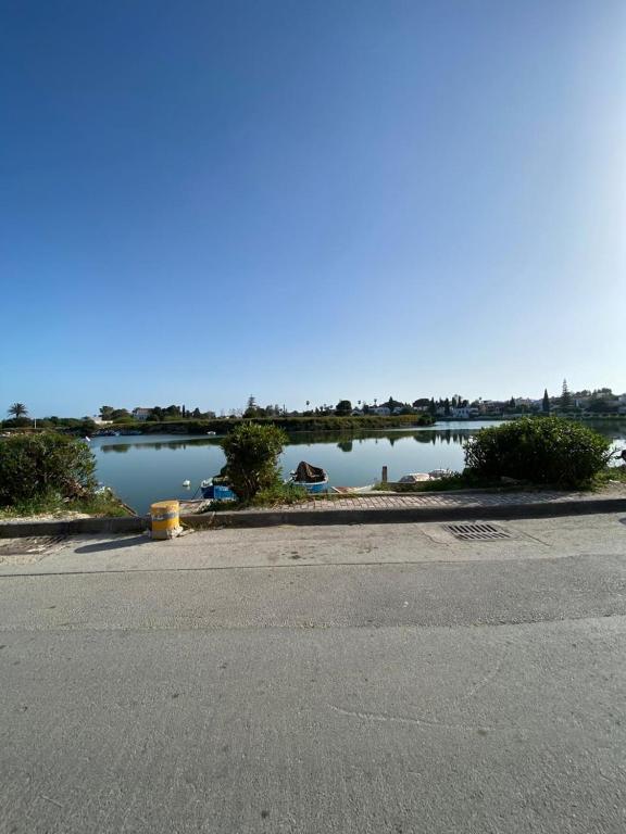 a parking lot with a view of a body of water at Le Cocon de Didon in Tunis