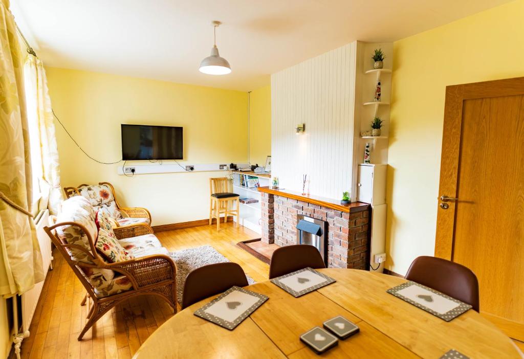 a living room with a table and a kitchen at Beentee View - Cahersiveen in Cahersiveen