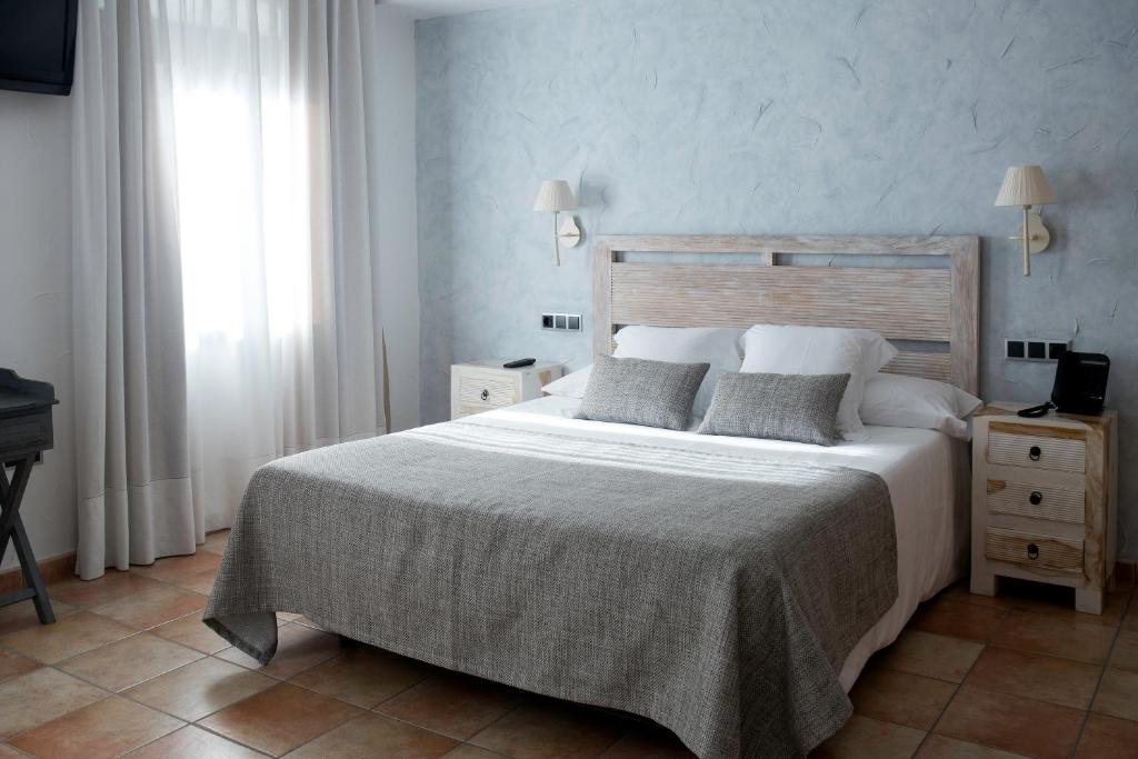Postel nebo postele na pokoji v ubytování Sa Voga Hotel & Spa