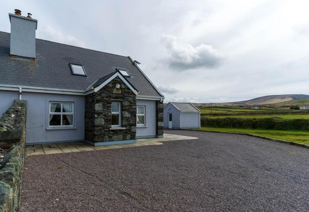 a house with a gravel driveway in front of it at 1 Bray Head View in Portmagee
