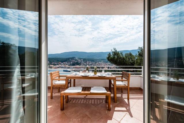 a table and chairs on a balcony with a view at Casa di Giorgio in Jelsa