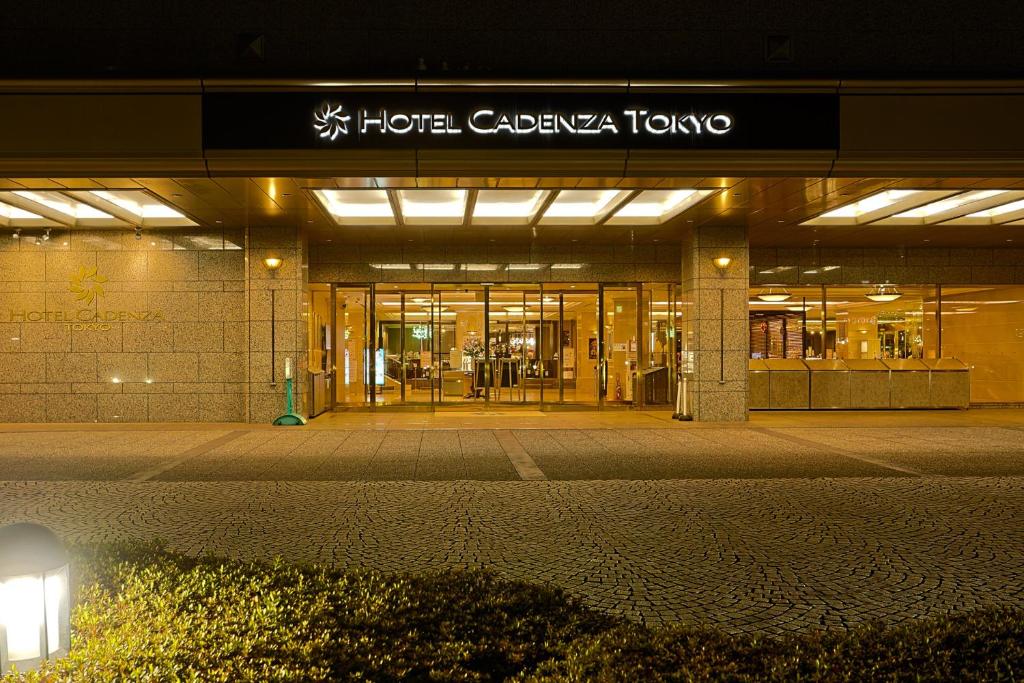 a building with a hotel california tokyo sign at night at Hotel Cadenza Tokyo in Tokyo
