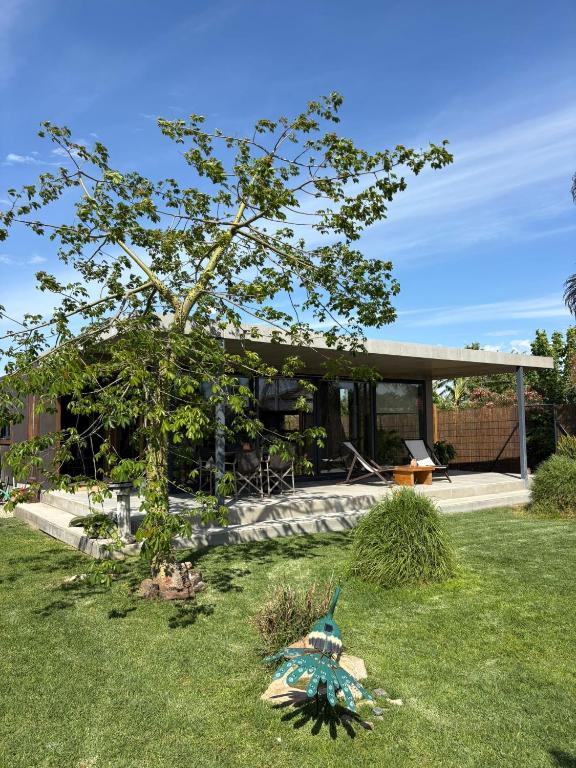 a house with a tree in the yard at Isabelina Stays near Doñana & the Coast in Sanlúcar de Barrameda