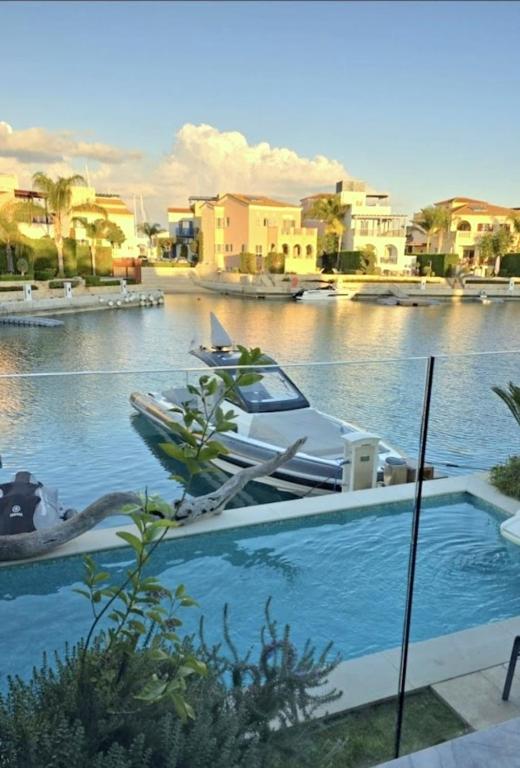 a boat in a river with buildings in the background at FINELINE Villa in Limassol