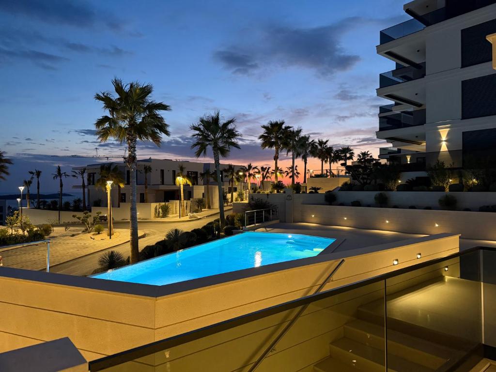 a swimming pool on the roof of a building at night at Pearl Garden in Primošten