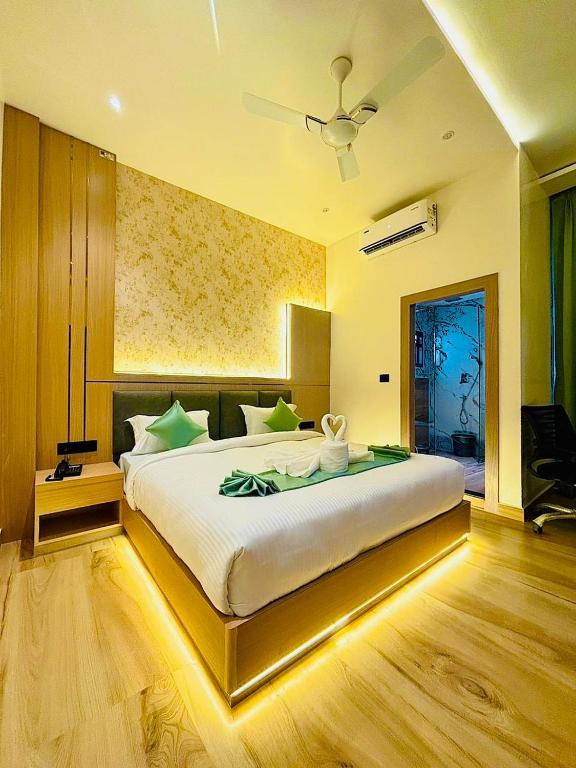 a bedroom with a large bed with a ceiling at Regal Havens in Jorhat