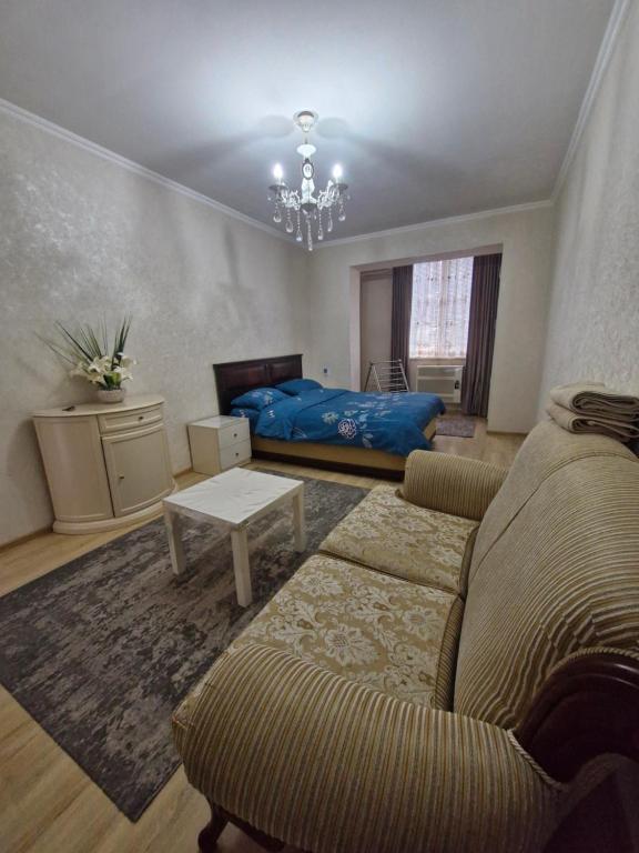 a living room with a couch and a bed at Rystavi in Rustavi