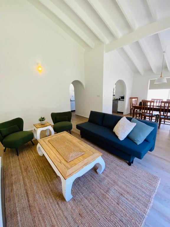 a living room with a blue couch and a coffee table at Mariners Rest in Redland Bay