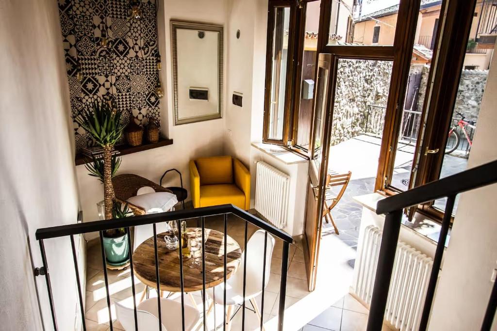 a room with a staircase with a chair and a table at FONTANE APARTMENTS in Salò