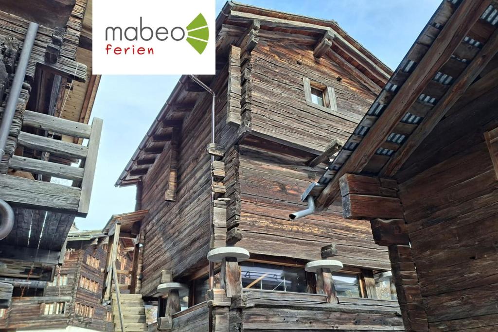 a wooden house with the noda farmer logo on it at Stadel de Riedmatten in Reckingen - Gluringen