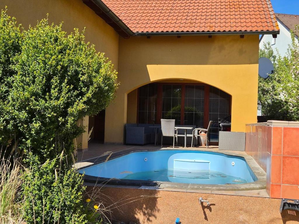 a swimming pool in front of a house at Vila Rozmital in Příbram