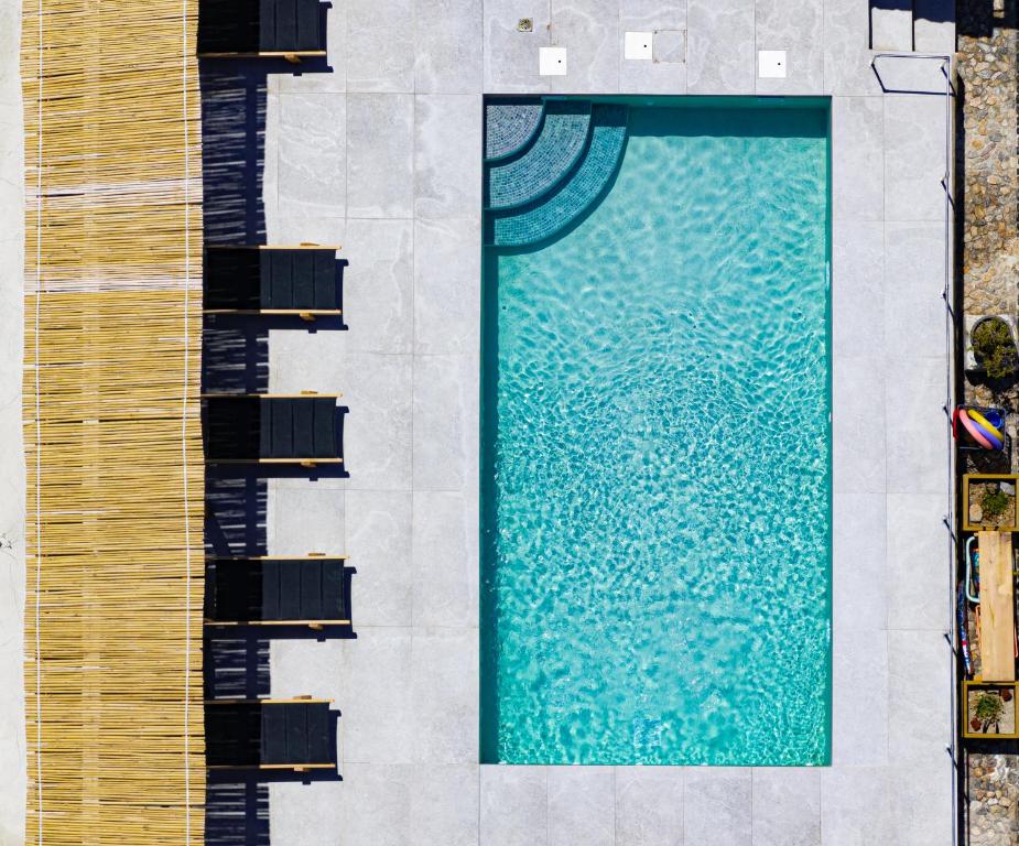 an overhead view of a swimming pool next to a building at Birds Villa Apartments with Heated Pool - Including Car and Breakfast in Perissa