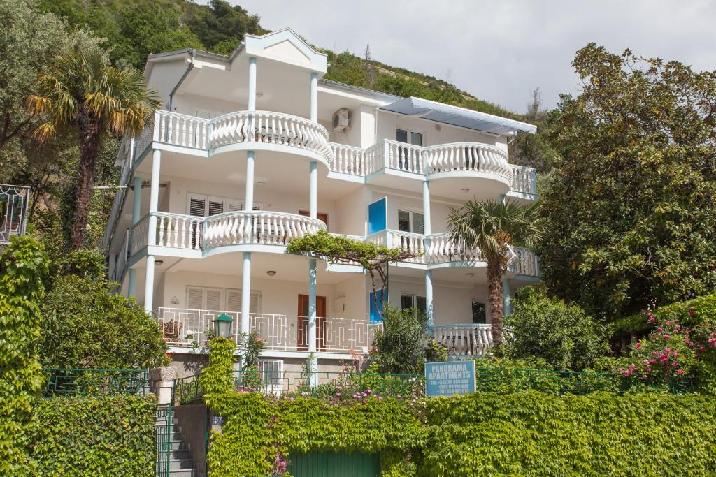 un gran edificio blanco con balcones y árboles en Panorama Apartments, en Budva