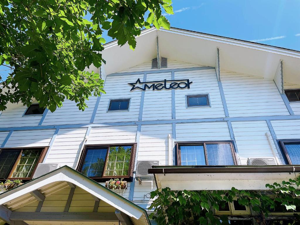 a nintendo sign on the side of a building at Hakuba Pension & Log Hotel Meteor in Hakuba