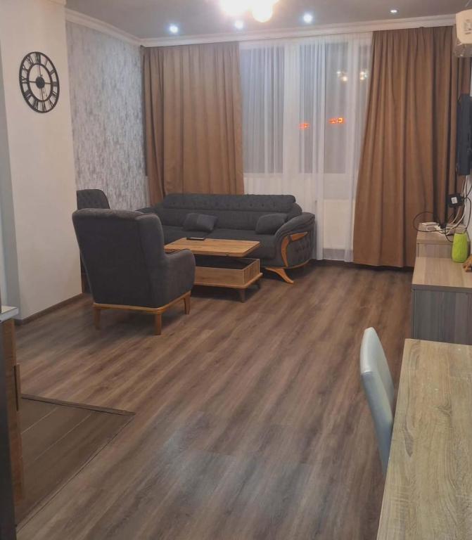 a living room with a couch and a table at ბინა მახინჯაურში in Makhinjauri
