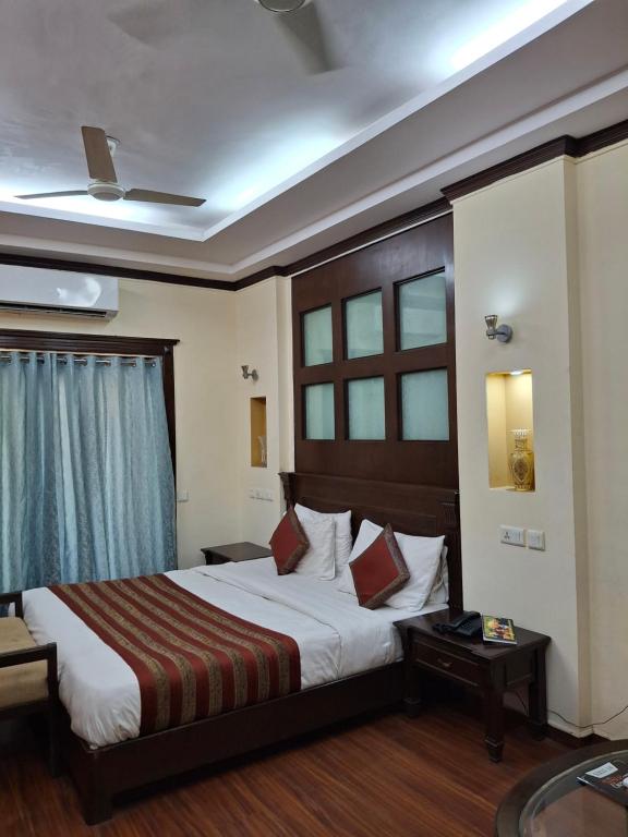 a hotel room with a bed and a window at Hotel Siris 18 in Gurgaon