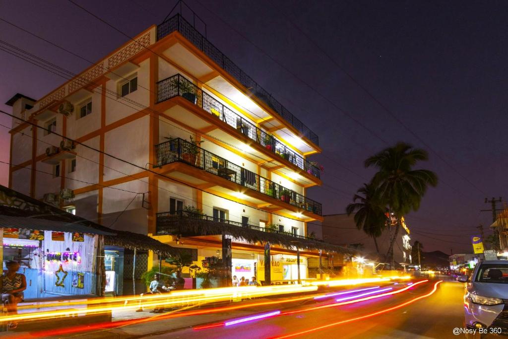 a building on a city street at night at VaoVao Hotel in Nosy Be