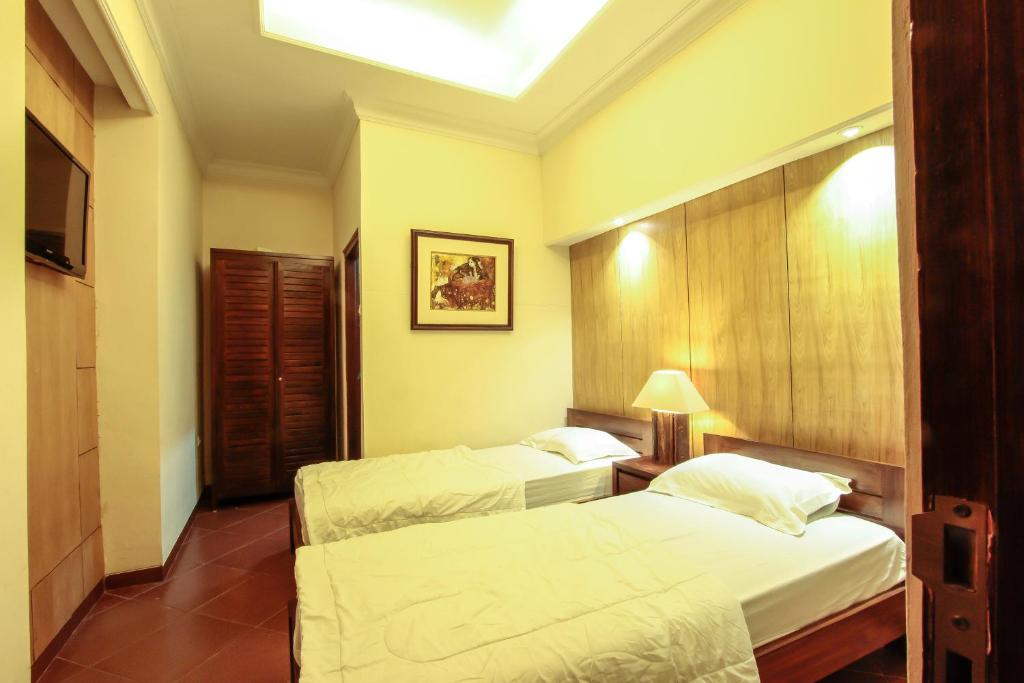 Postel nebo postele na pokoji v ubytování Griya Langen Guesthouse