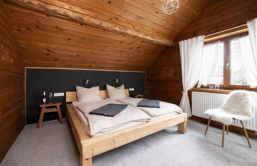 a bedroom with a large bed in a wooden room at Gästehaus Kaufmann in Mellau