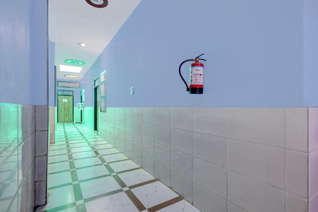an empty hallway of a hospital with a blue light at Spot On Moonlight Hotel in Jhajjar