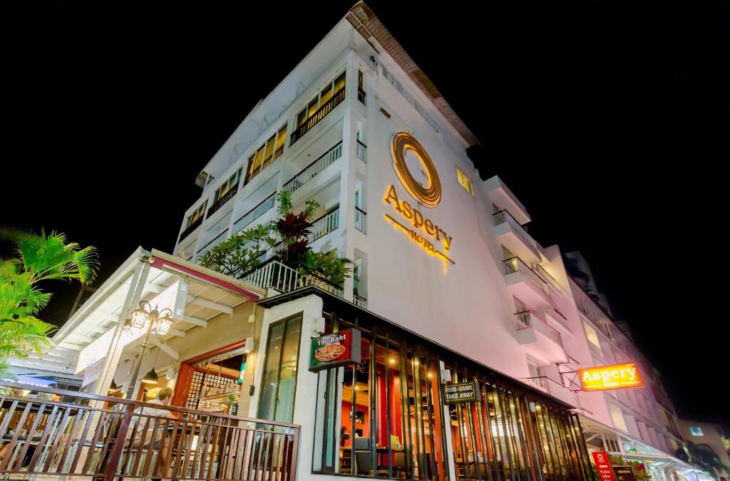 a building with a sign on the side of it at Aspery Hotel - SHA Certified in Patong Beach