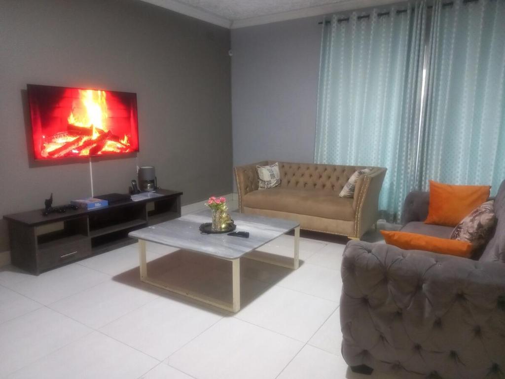 a living room with a couch and a coffee table at Alamaison in Umtali