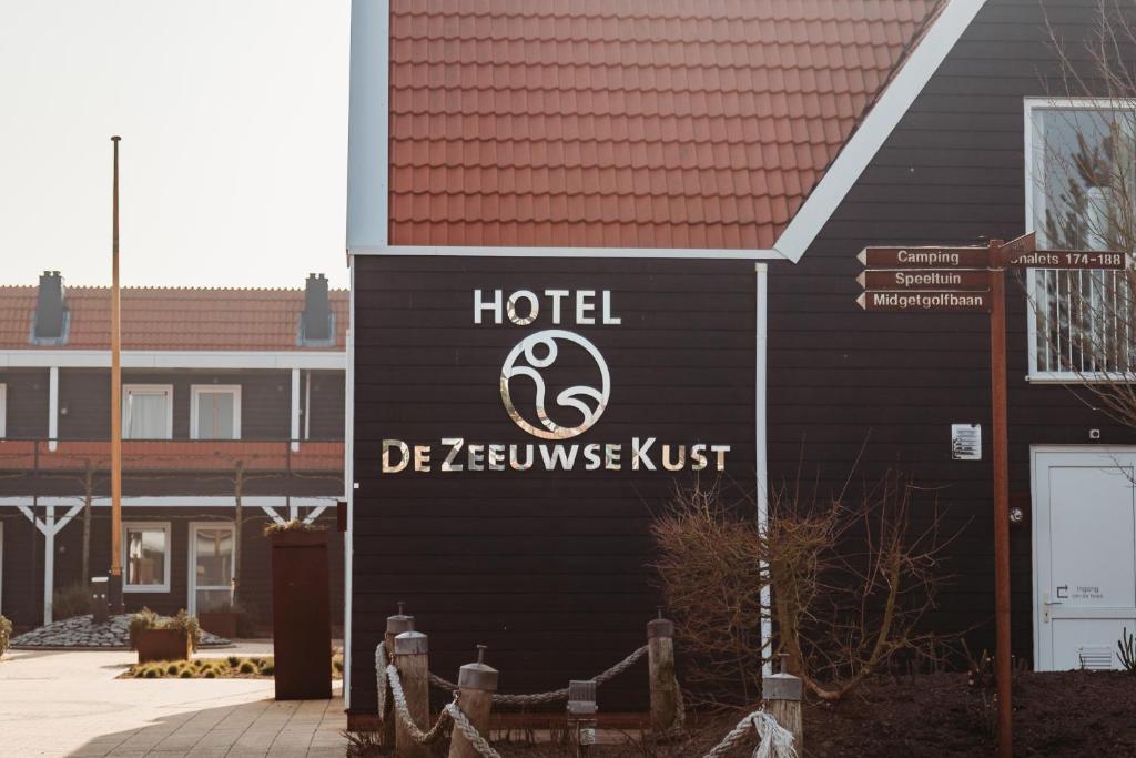 a hotel sign on the side of a building at Hotel De Zeeuwse Kust (family only) in Renesse
