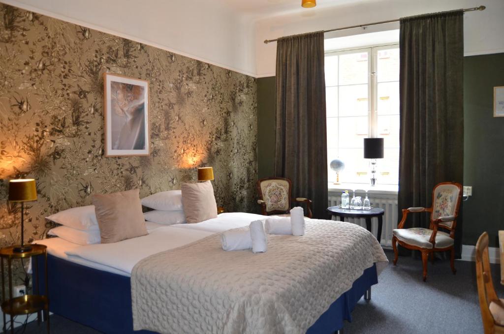 a hotel room with a bed and a window at Leopold Boutique Hotel in Östersund