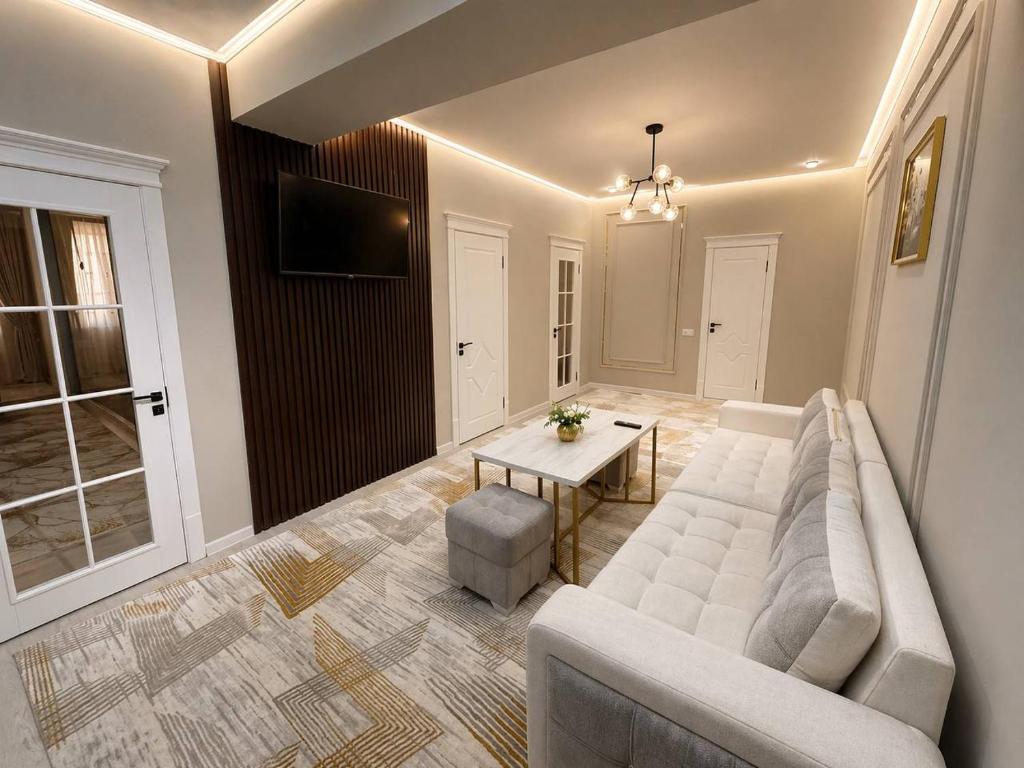 a living room with a couch and a table at Runa modern flat in Samarkand
