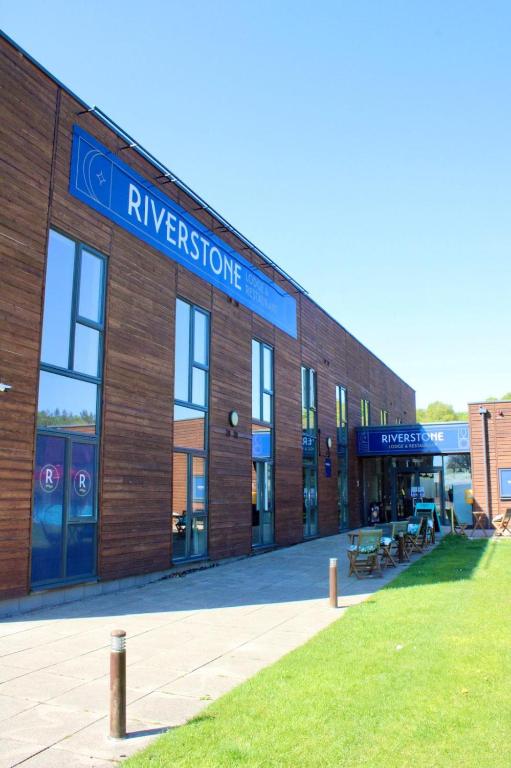 a large brick building with a sign on it at Riverstone Lodge Hotel in Perth