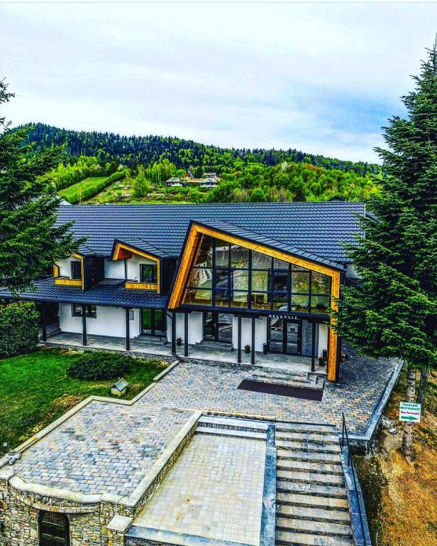 a house with a large window on top of it at Casa Elena - Resort & SPA in Voronet