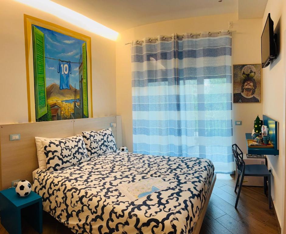 a small bedroom with a bed and a desk at Foria 143 in Naples