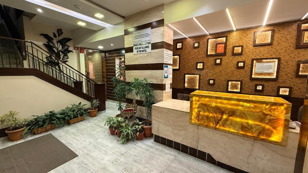 a lobby with a large fountain in the middle at Hotel New Sunder in Indore