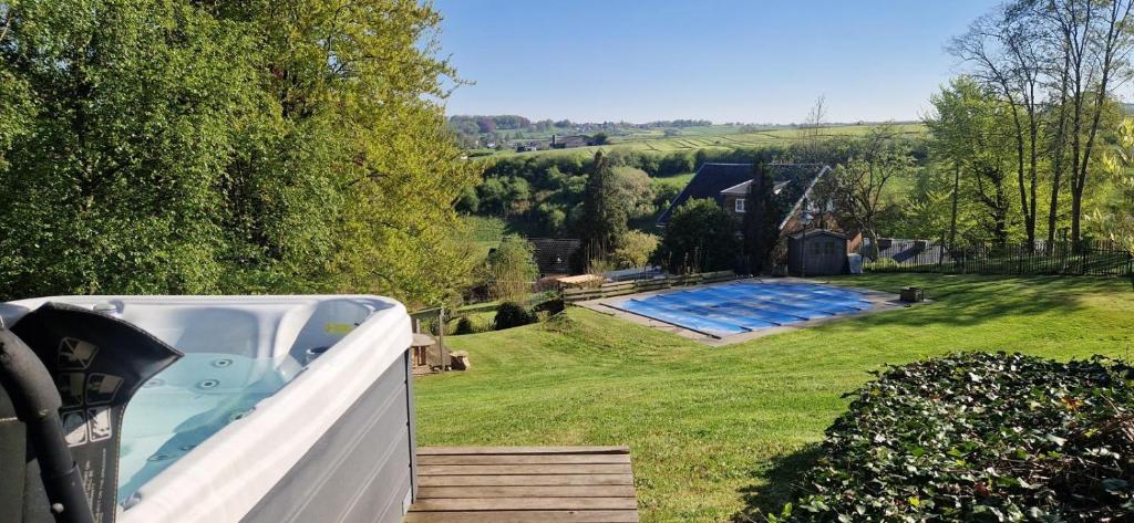 a hot tub in the backyard of a house at Rouges Terres in Theux