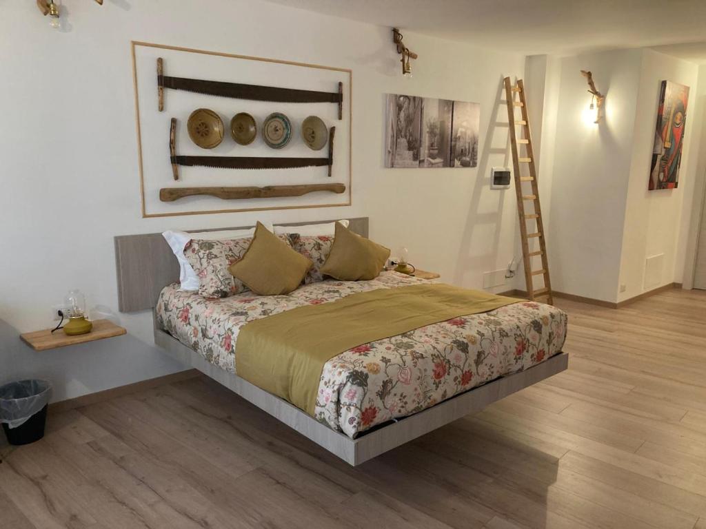 a bedroom with a bed and a painting on the wall at Mamma Adelina in Enna