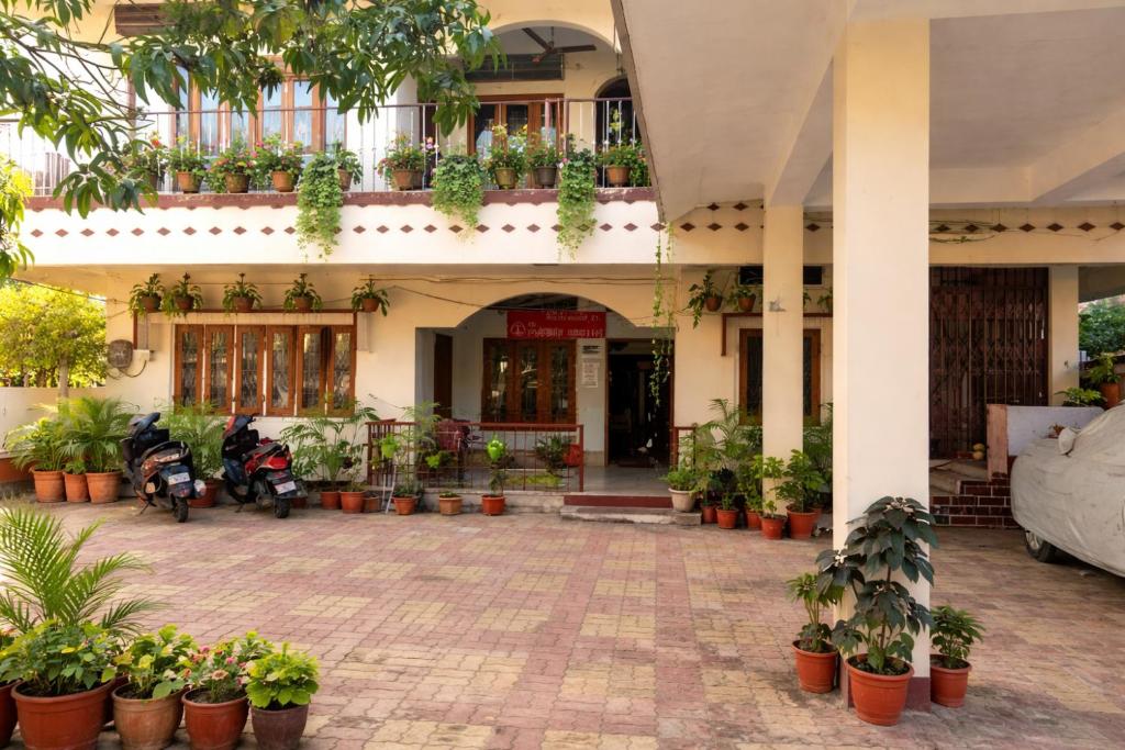 a building with a bunch of potted plants and motorcycles at The Pinnacle Stays in Guwahati
