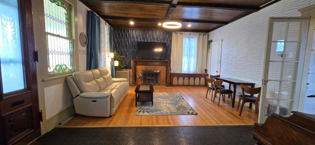 a living room with a couch and a table at Distinguished Home in Scranton
