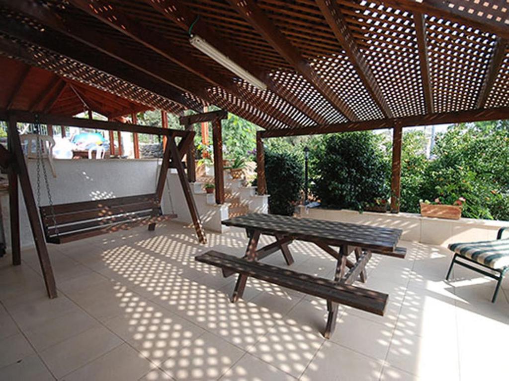 a patio with a picnic table and a bench at Lea's - Spirit of the Galilee in Migdal