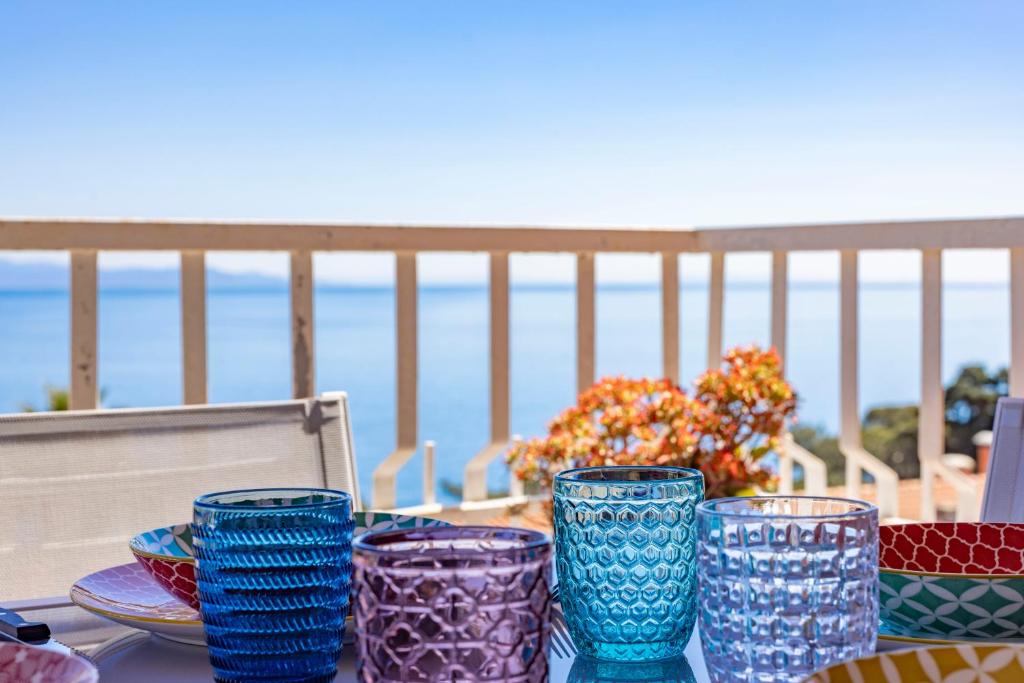 a group of blue glass vases sitting on a table at Marina Elite Capo D'Arco in Capo D'Arco