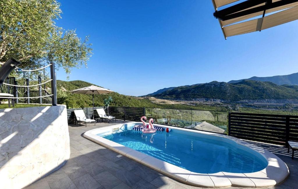 a person in a swimming pool in a house at Beautiful Home In Vrgorac in Vrgorac
