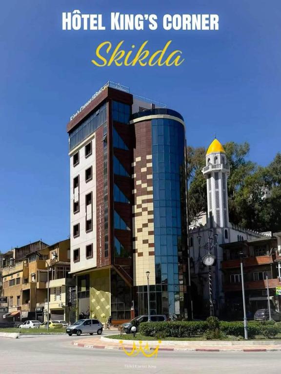 a building with a clock tower in a city at Hôtel Corner King in Skikda