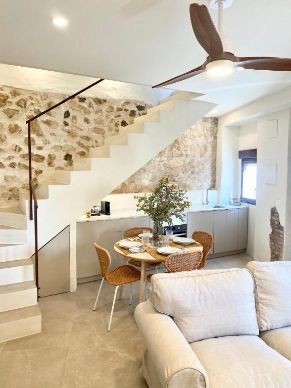a living room with a table and a staircase at Casa Marítima in Altea