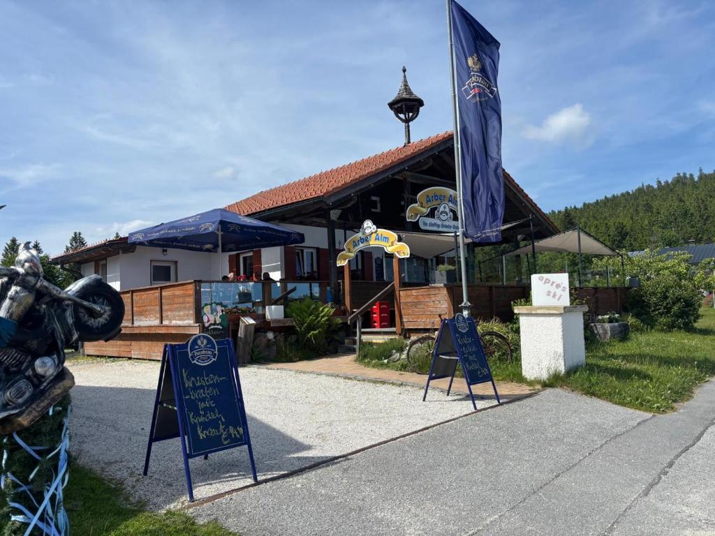 a restaurant with signs in front of a building at Arber Alm in Bayerisch Eisenstein